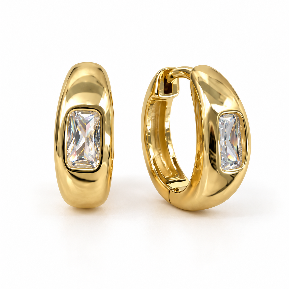 A pair of gold huggie hoop earrings with rectangular pink gemstones, shown from front and side angles 