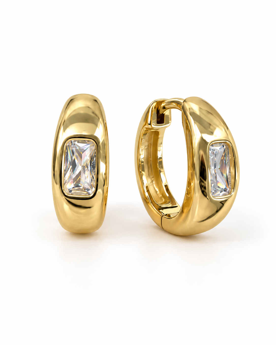 A pair of gold huggie hoop earrings with rectangular pink gemstones, shown from front and side angles 
