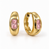 A pair of gold huggie hoop earrings with rectangular pink gemstones, shown from front and side angleS.