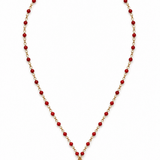 A gold chain necklace featuring small coral beads and a gold padlock pendant.