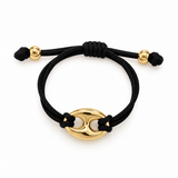 A black adjustable cord bracelet with a polished gold-tone oval centerpiece and small gold beads on the cord