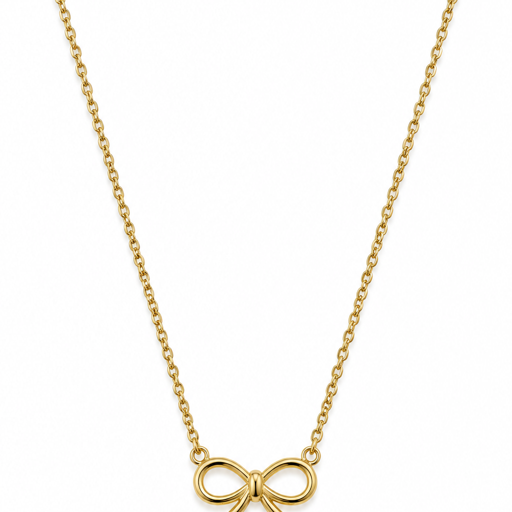 A delicate gold chain necklace featuring a small bow-shaped pendant.