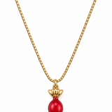 A gold chain necklace featuring a pendant shaped like a wrapped candy, with a glossy red center bead