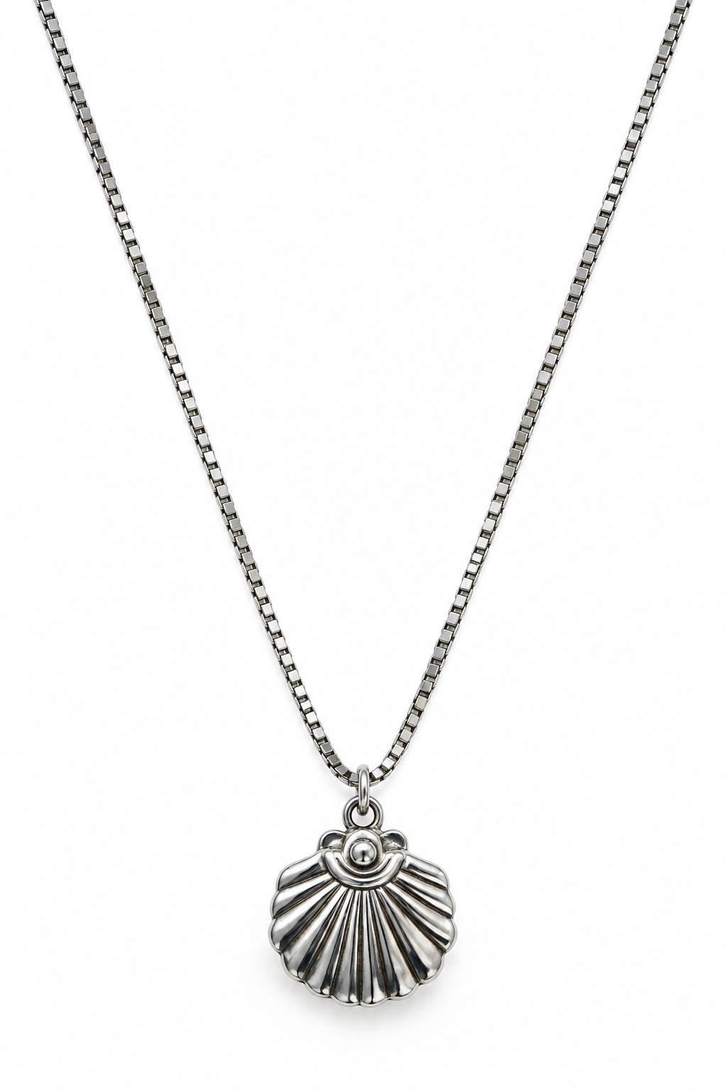 A silver-toned chain necklace with a textured, scallop-shaped shell pendant.