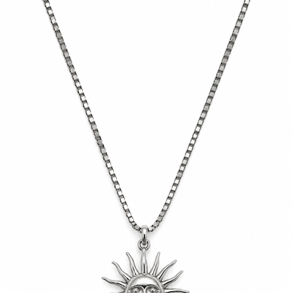 A silver-toned sun pendant necklace with a detailed sun face and radiating rays.