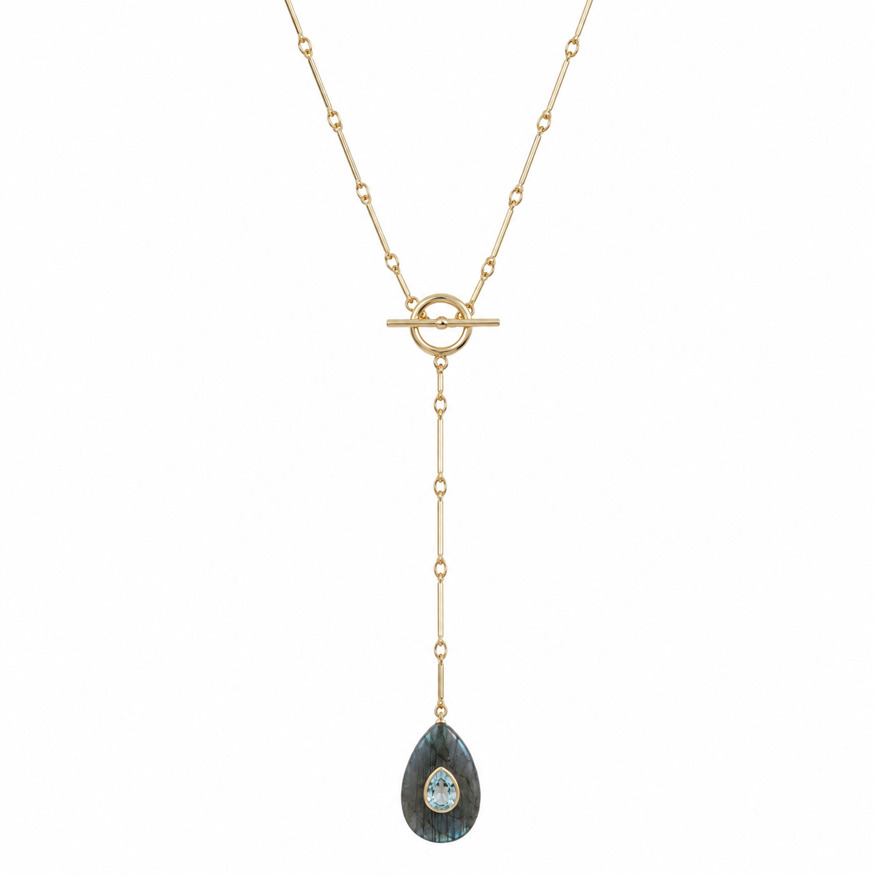 gold chain lariat with toggle clasp in the middle with a teardrop shaped labradorite stone pendant with a light blue pear shaped cz in the middle