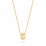 Gold necklace with a teardrop-shaped yellow gemstone on a white background