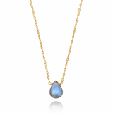 Gold necklace with a teardrop-shaped gemstone pendant on a white background