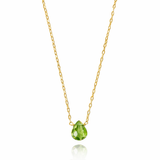 Gold necklace with a green teardrop pendant on a white background