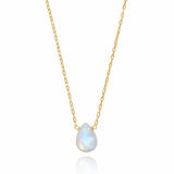 Gold necklace with a teardrop-shaped white gemstone on a white background