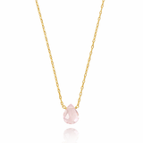 Gold necklace with a pink teardrop pendant on a white background