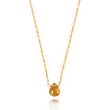 Gold necklace with a teardrop-shaped pendant on a white background